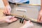 Male and female hands placing kitchen cabinet handles in configuration to make a selection for their home interior decor