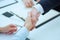 Male and female handshake in office. Businessman in suit shaking woman`s hand.