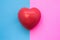 Male and female heart. Heart lies on two colors in background - blue and pink which symbolize man and woman. Medical features, uni
