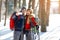 Male and female hikers taking photos on winter in wood