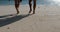 Male And Female Legs Coming To Water On Beach Closeup. Back Rear View Couple Barefood Walking On Sand