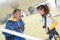 Male and female parachutists under wing aircraft