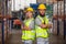 Male and Female professional worker wearing safety uniform using tablet inspect goods on shelves in warehouse. supervisor worker