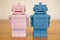 Male and female robot - pink and blue on a table