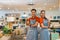 male and female shop assistants with thumbs up smiling at the camera