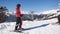 Male and female skiers on the mountain. A woman arrives on skis to male and the couple communicates.