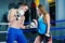 Male and female sporty couple practicing boxing at the gym at boxing ring.