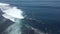 Male and female surfers rides breaking waves in the blue ocean