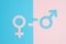 Male and female symbols cut out of paper and an equal sign on a pink and blue paper background. the concept of gender equality