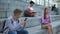 Male female teenagers chatting smartphone sitting beside, online communication