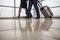 Male and female are walking at terminal with luggage