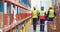 Male and female warehouse worker carrying cardboard boxes