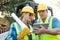 Male and Female Workers With Blueprints and Computer Tablet