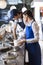 Male And Female Workers Preparing Ice Creams At Counter