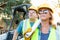 Male and Female Workers With Technical Blueprints at Construction Site