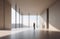 male figure in beige-toned minimalist architectural interior. stark, sunny concrete space