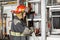 Male Firefighter Adjusting Hose In Truck