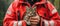 a male firefighter holding a gray cat, a red jacket, pet rescue, the concept of dangerous and