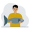 A male fisherman holds a large fish, proud of good fishing or hunting. Hobby, fishing concept.