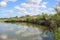 Male fishermen sit on the Bank of the river fishing with fishing rods in the summer