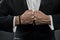 Male fists with swollen veins and bracelet on formal suit background. Confrontation concept. Hand of business person