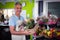 Male florist carrying plant pot in wicker basket