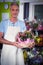 Male florist carrying plant pot in wicker basket