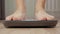 Male foot stepping on weight scale for weighting close up. Health and wellness