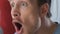 Male football supporter blowing fan horn, celebrating goal at stadium, close-up