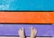 Male foots on color planks on a beach