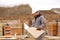 Male foreman looking at drawing plan of hause at construction site.