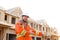 Male foreman showing construction site, building in background.