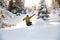 Male freeride snowboarder jumping the mountain snowcovered slope
