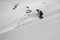 Male freerider glides down the snowy mountain slope