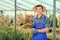 Male gardener holding flower pots