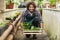 Male gardener keeping plants crate on floo