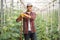 Male gardener posing on a cucumber field