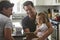 Male gay dads use tablet with daughter in kitchen, close up