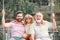 Male generation family together with three different generations ages grandfather father and son having fun on a swing