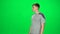 Male goes and dances, smiles and rejoices on a green screen, Chroma Key