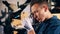 Male goldsmith is observing a ring through the magnifying glass. Jeweler working jewelry