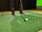 Male golfer plays golf indoors on golf simulator closeup