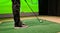 Male golfer plays golf indoors on golf simulator closeup