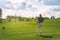 Male golfer standing at fairway on golf course