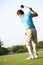 Male Golfer Teeing Off