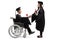 Male graduate student in a wheelchair shaking a hand with a female graduate student