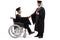 Male graduate student in a wheelchair shaking hand with a male graduate student standing and holding a diploma