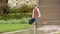 Male guitarist musician walks down path in rain