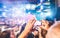 Male guy making video live of summer festival concert with mobile phone - Crowd celebrating party event - Soft focus on hands -