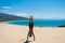 Male guy with a muscled back doing a handstand in a beautiful dune next to the atlantic in Tarifa, Spain